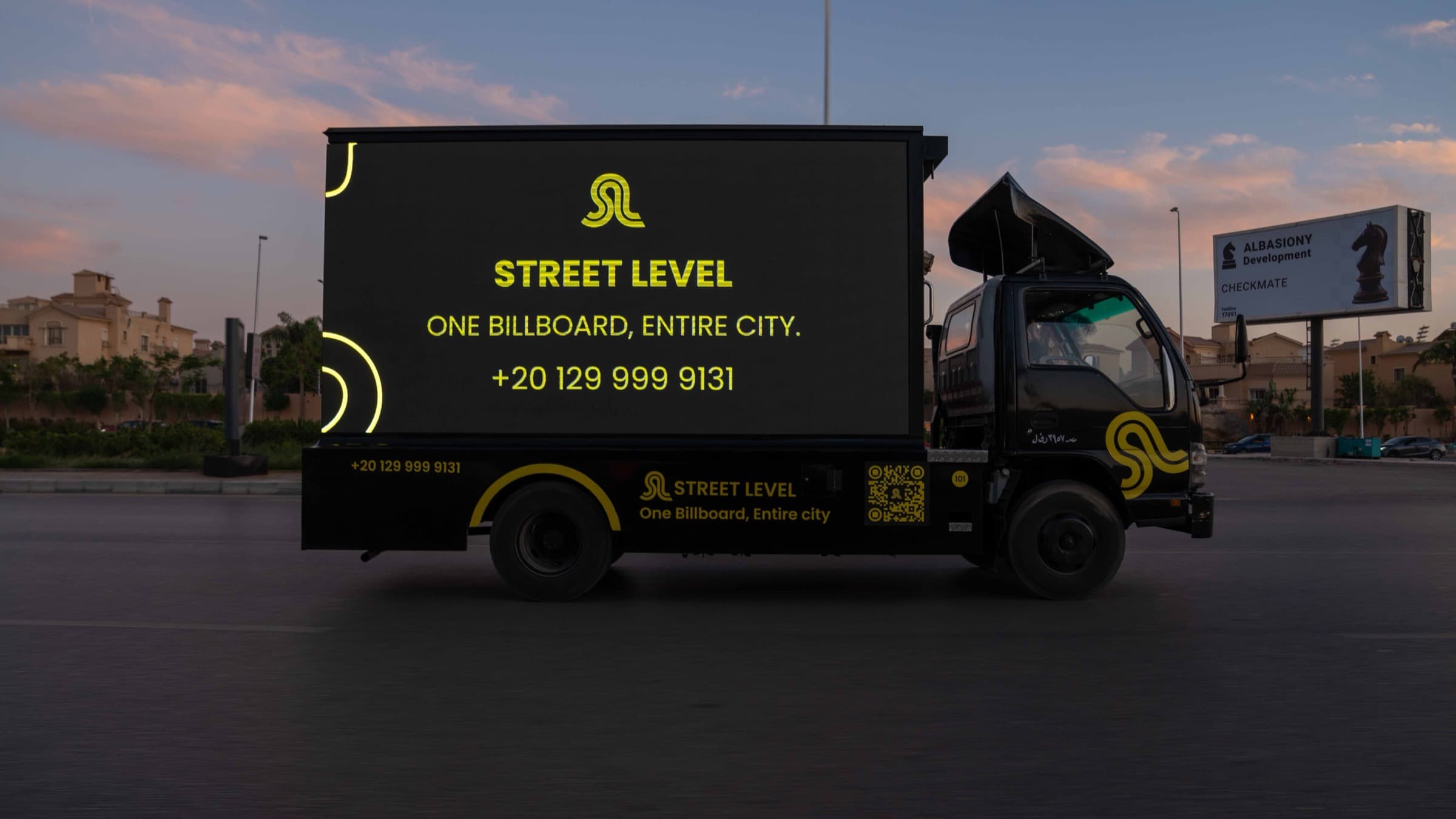 Mobile LED billboard truck displaying advertisements on Cairo streets at night