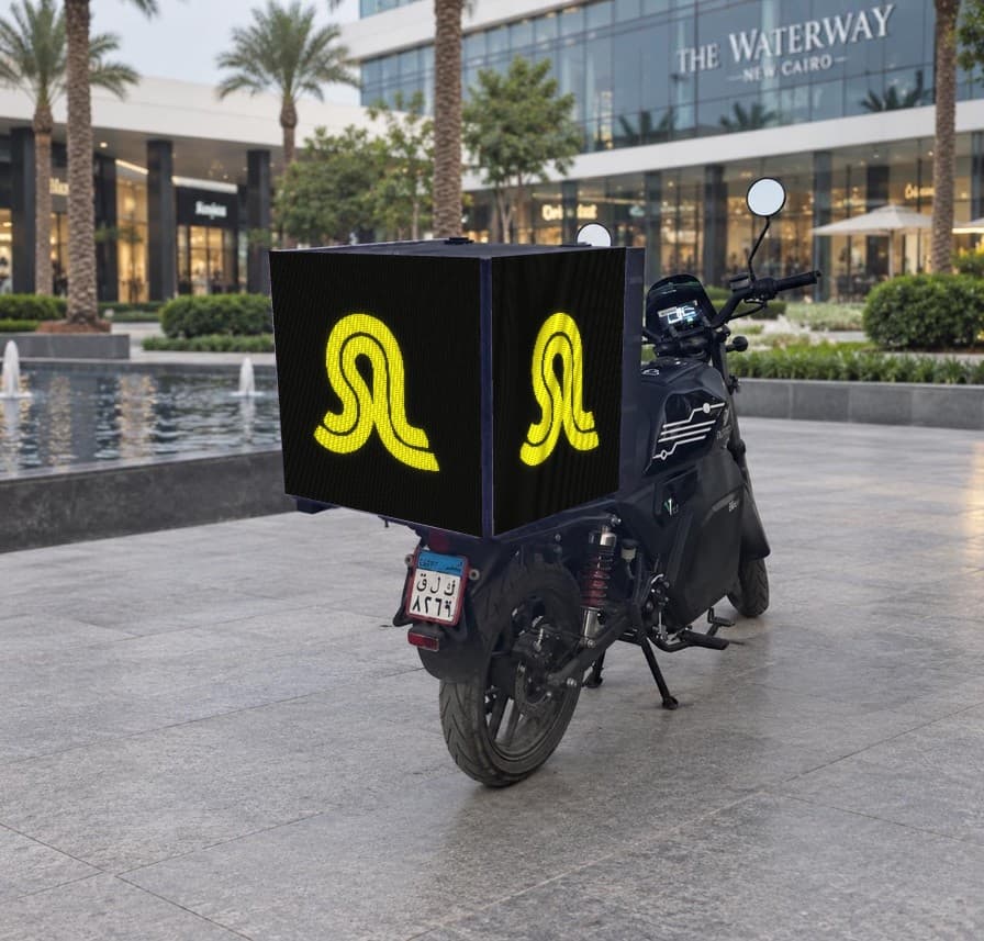 Delivery bike parked at The Waterway in New Cairo, with the Street Level logo on its screens