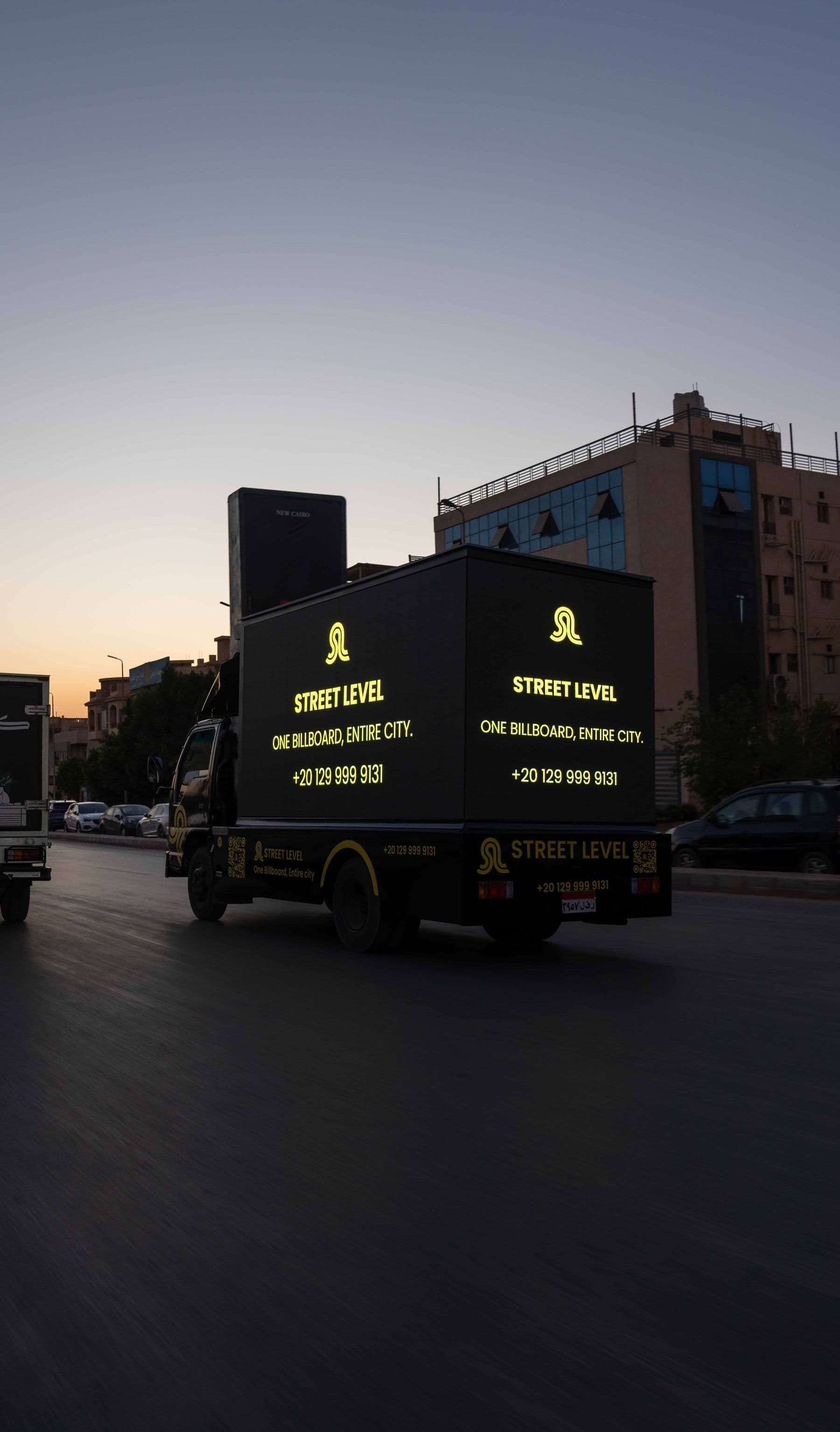 Street Level truck at dusk with the Street Level logo on its screens